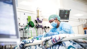 En sygeplejerske behandler en patient på en intensivafdeling for coronapatienter. Af de 770 indlagte i Danmark er 73 på intensiv. (Arkivfoto). Foto: Ólafur Steinar Gestsson/Ritzau Scanpix